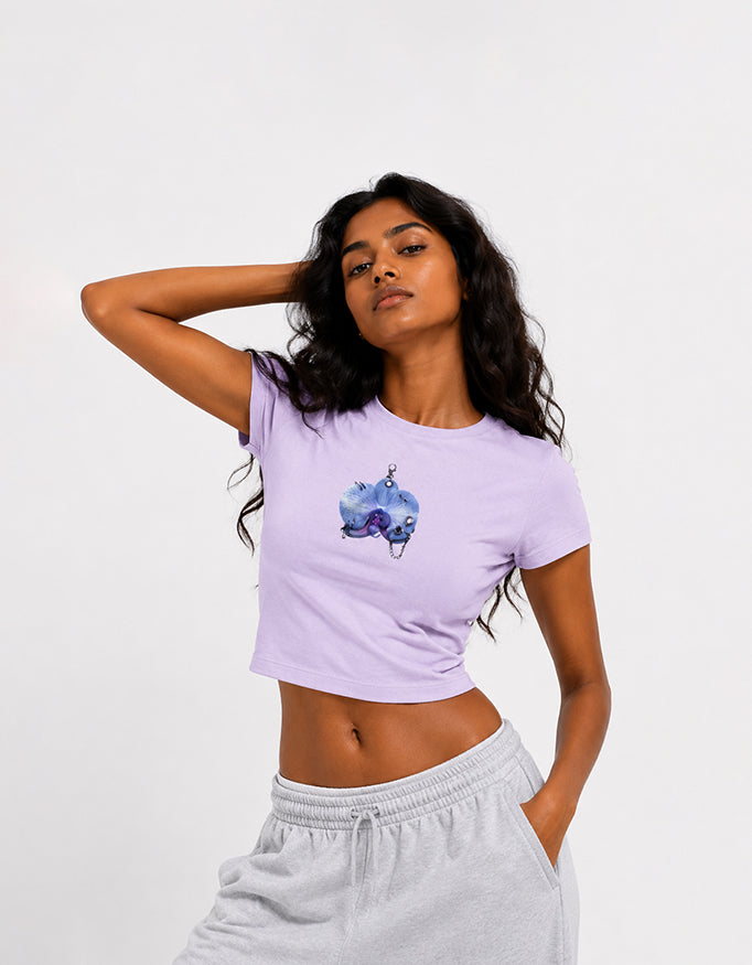Female model wearing GUILTY PARTY black cropped baby tee with blue front graphic print