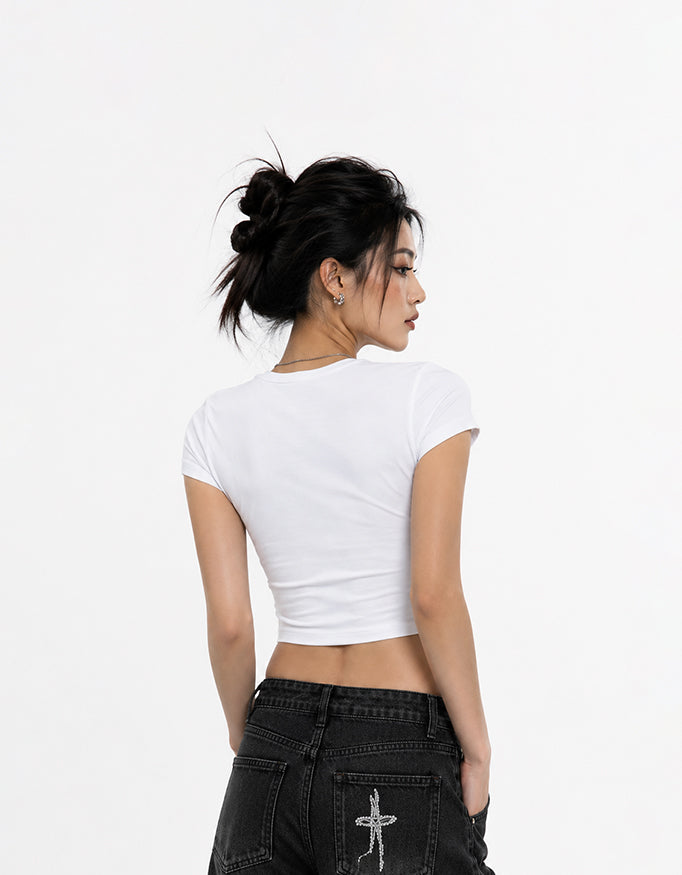 Female model wearing GUILTY PARTY white cropped baby tee with vintage camera Capture The Moments graphic print