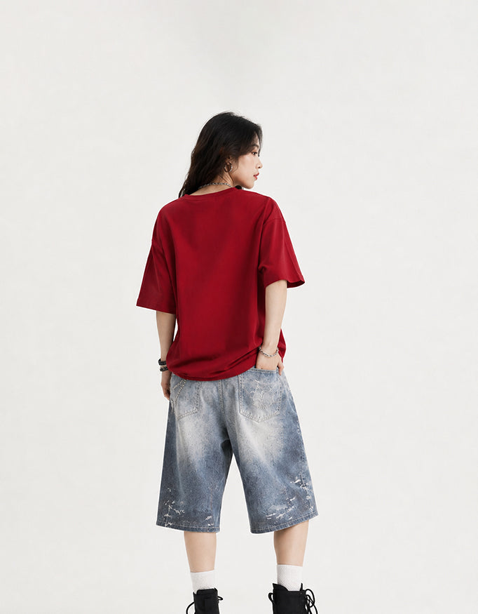 Female model wearing GUILTY PARTY red oversized Insane B!tch graphic t-shirt with abstract Hindi typography and lip print