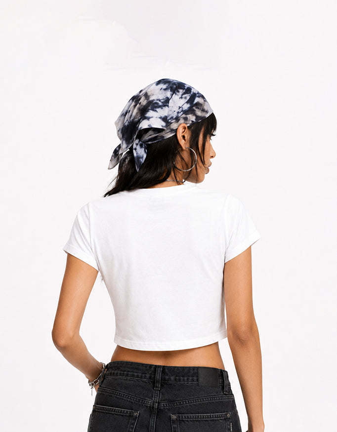 Female model wearing GUILTY PARTY white cropped baby tee with Local Woman pink graphic print