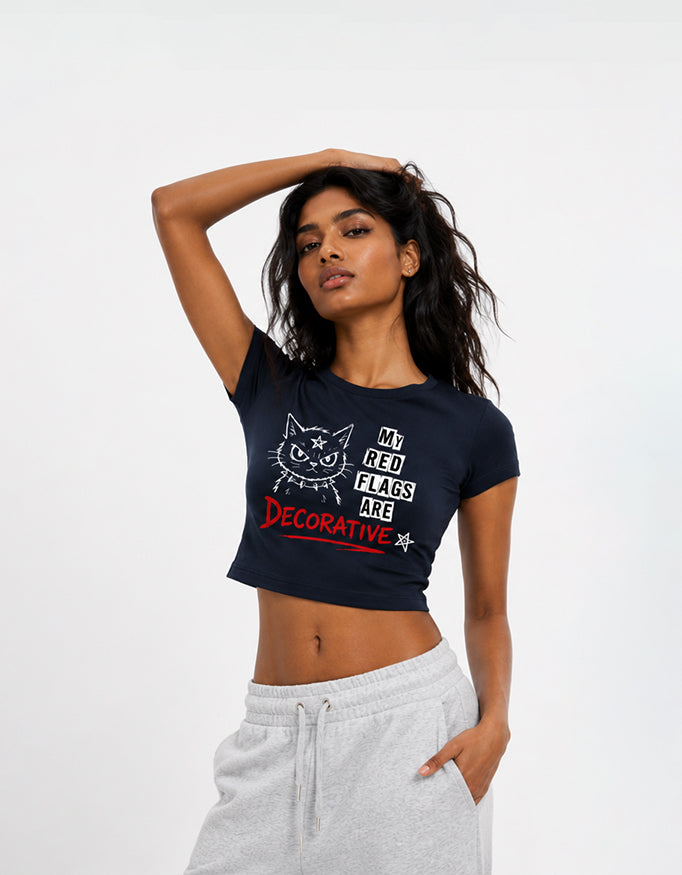 Female model wearing GUILTY PARTY navy cropped baby tee with My Red Flags Are Decorative graphic print
