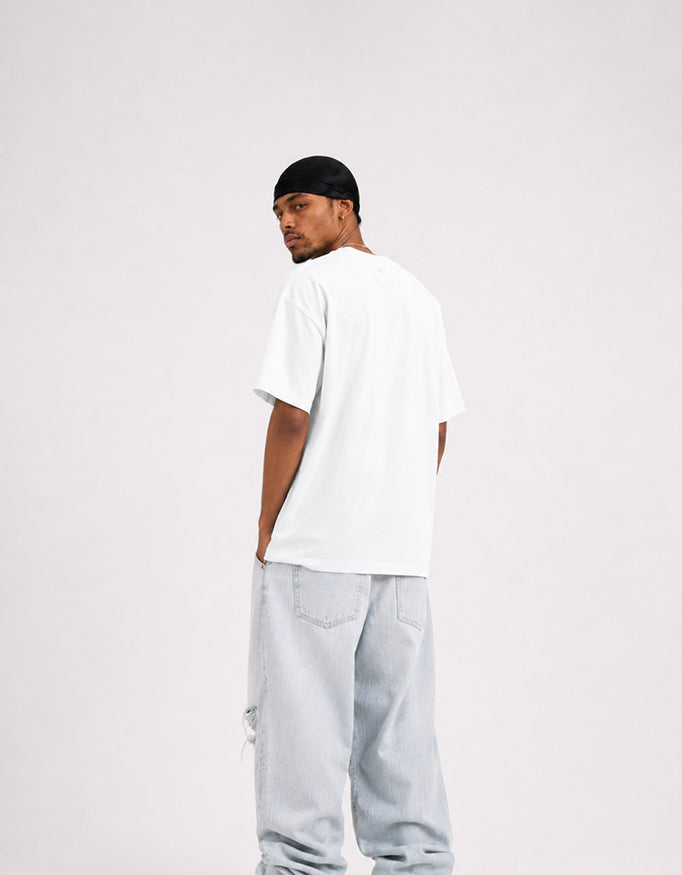 Male model wearing GUILTY PARTY white oversized ribcage graphic t-shirt