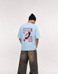 Back view of GUILTY PARTY baby blue oversized tee with red phone graphic and statement typography
why'd you only call me when you're high?