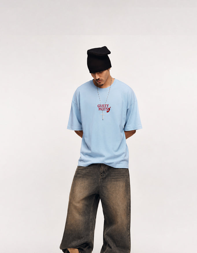 Male model wearing GUILTY PARTY baby blue oversized tee with small red front logo