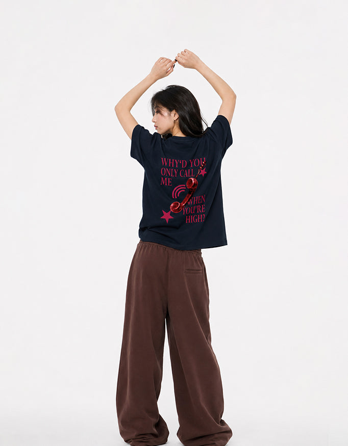 Back view of GUILTY PARTY navy blue oversized tee with red phone graphic and statement typography why'd you only call me when you're high?