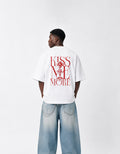Back view of GUILTY PARTY white oversized tee with bold red Kiss Me More graphic print