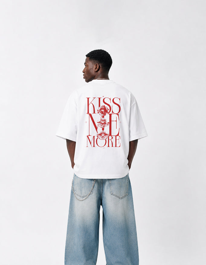 Back view of GUILTY PARTY white oversized tee with bold red Kiss Me More graphic print